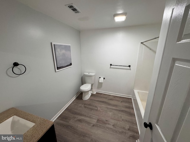 full bathroom with vanity, toilet, hardwood / wood-style floors, and plus walk in shower