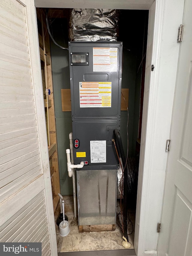 utility room featuring heating unit