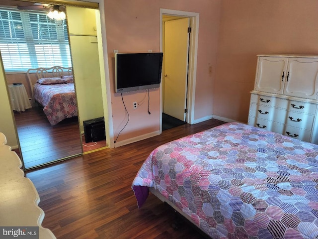 bedroom with dark wood-type flooring