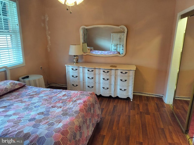 bedroom with dark wood-type flooring