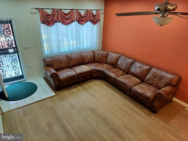 unfurnished living room featuring ceiling fan and light wood-type flooring