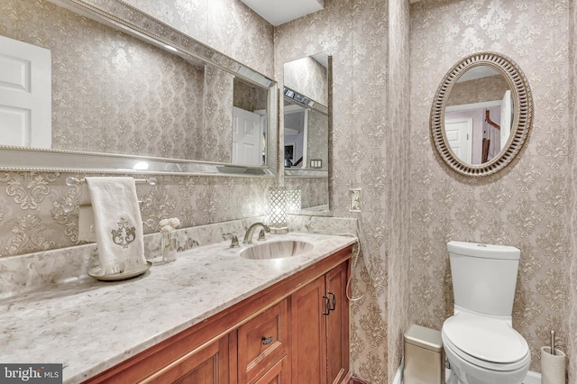 bathroom featuring vanity and toilet