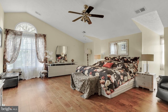 bedroom featuring hardwood / wood-style floors, vaulted ceiling, and ceiling fan