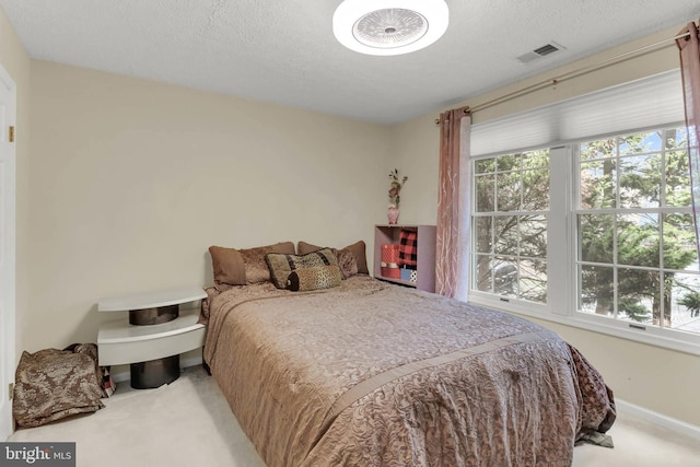 carpeted bedroom with a textured ceiling