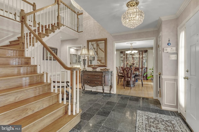 foyer featuring crown molding and a notable chandelier