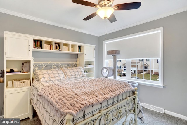 carpeted bedroom featuring ornamental molding and ceiling fan