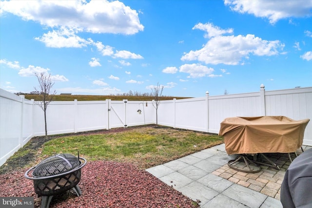 view of yard featuring a patio area and a fire pit