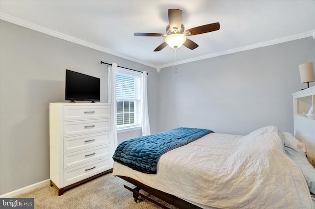 carpeted bedroom with ceiling fan and ornamental molding