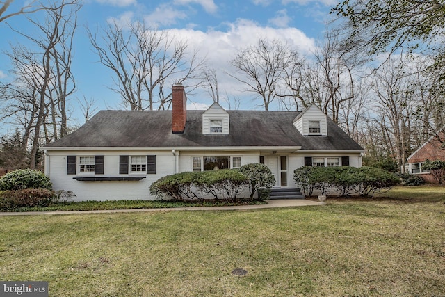 cape cod-style house with a front yard, brick siding, and a chimney