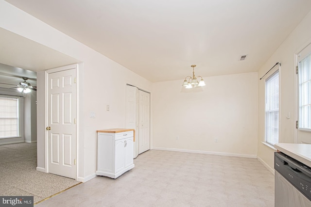 interior space with ceiling fan with notable chandelier, light floors, visible vents, and baseboards