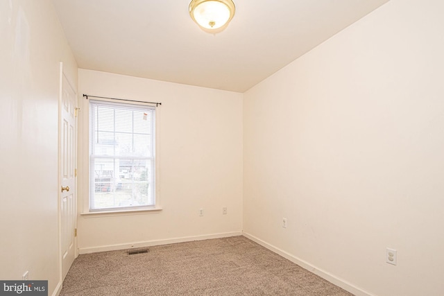 unfurnished room with baseboards, visible vents, and carpet flooring