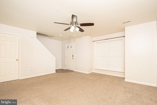 unfurnished bedroom featuring carpet floors, baseboards, visible vents, and a ceiling fan