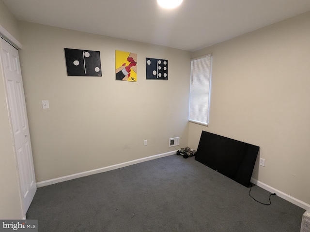 interior space featuring dark colored carpet