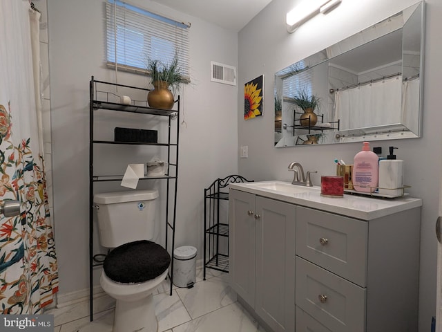 bathroom featuring vanity and toilet