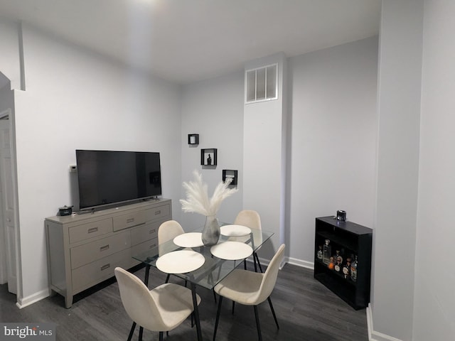 dining area featuring dark wood-type flooring