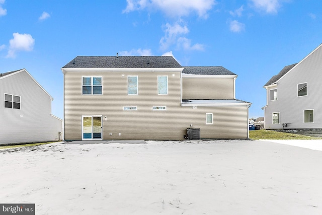 rear view of property with central AC