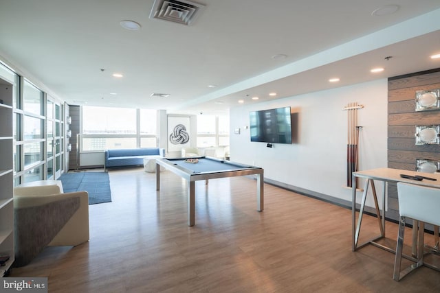 recreation room with billiards, a wall of windows, and light wood-type flooring