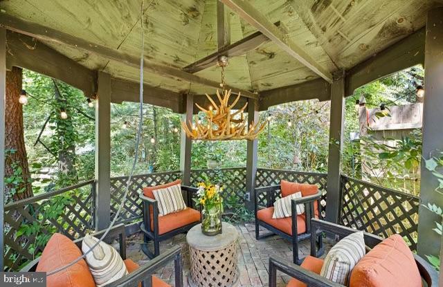 wooden deck featuring a gazebo and outdoor lounge area