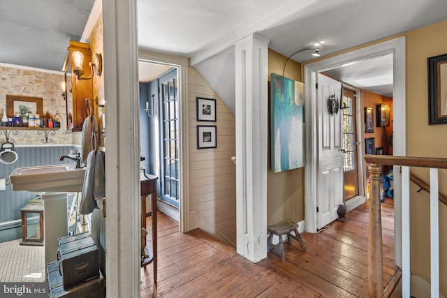 corridor featuring wainscoting and wood finished floors