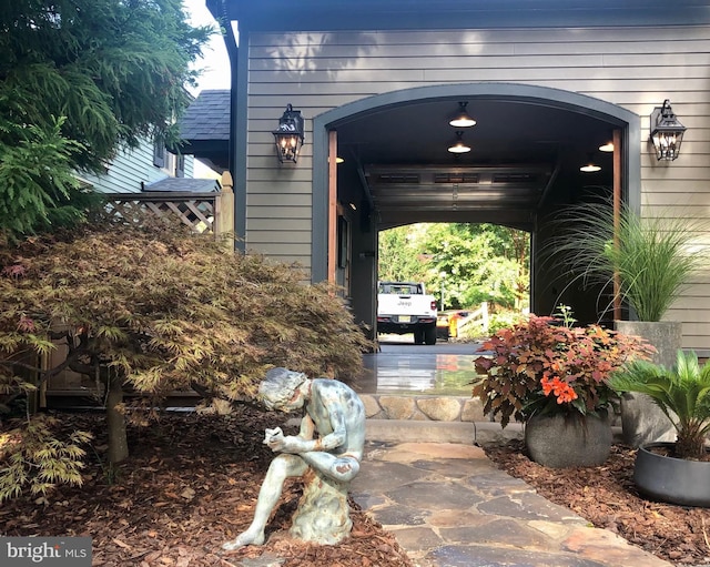 view of exterior entry with a shingled roof