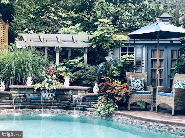 outdoor pool featuring a pergola