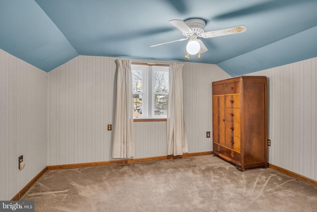 additional living space featuring ceiling fan, light colored carpet, and lofted ceiling