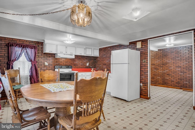 dining area featuring beamed ceiling, ornamental molding, and brick wall