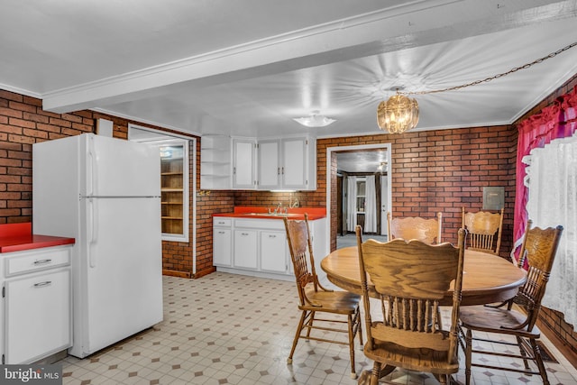 dining space with sink and brick wall