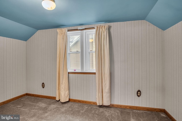 bonus room with vaulted ceiling and carpet