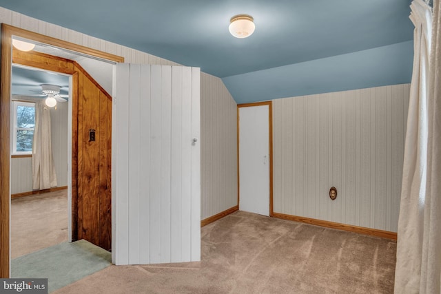 bonus room with vaulted ceiling and light carpet