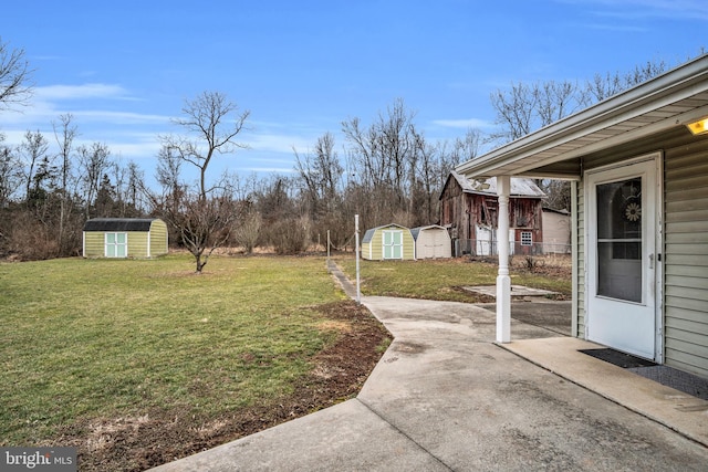 view of yard with a shed and a patio area