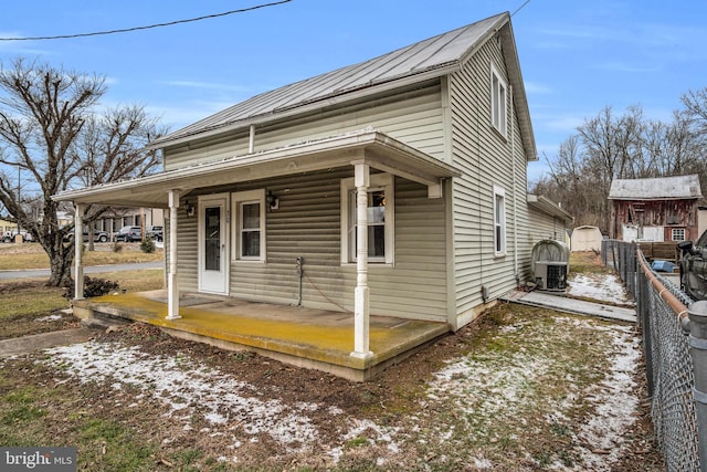 view of front facade with covered porch and central air condition unit