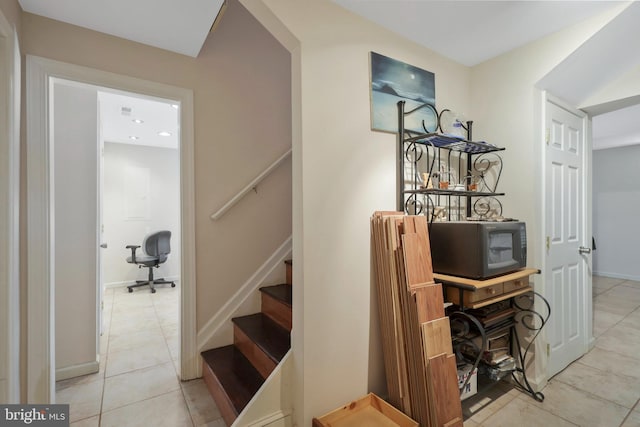 staircase featuring tile patterned flooring