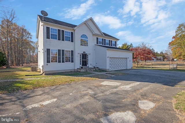 view of front of house with a garage and a front lawn