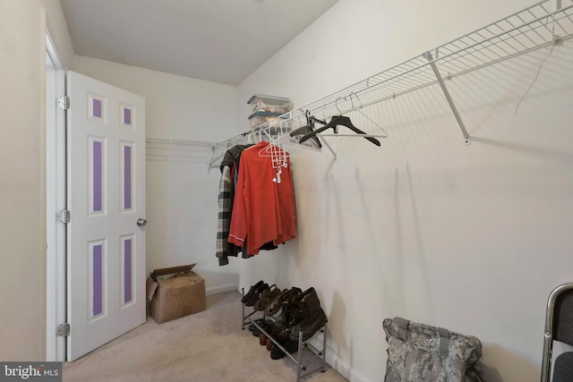 spacious closet featuring light carpet