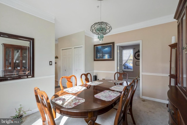 carpeted dining area featuring crown molding and a chandelier