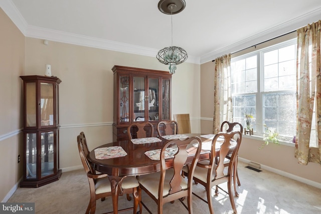 carpeted dining area with crown molding and a chandelier