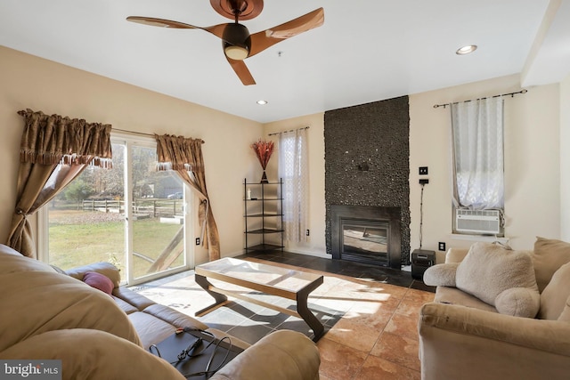 living room with ceiling fan, cooling unit, and a fireplace