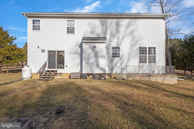 rear view of property with a lawn