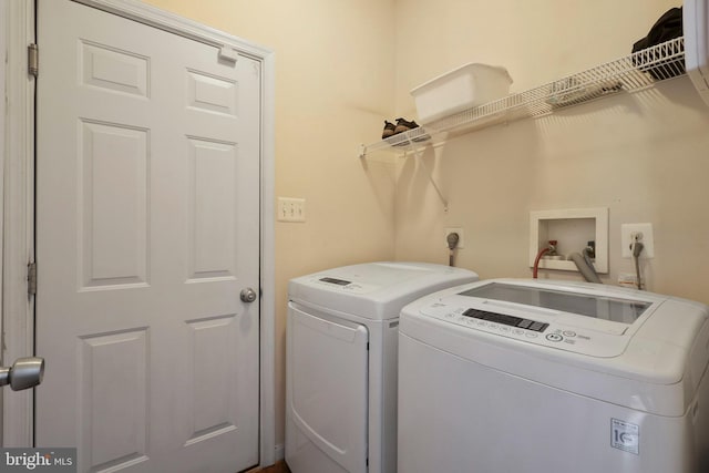 clothes washing area featuring washer and clothes dryer