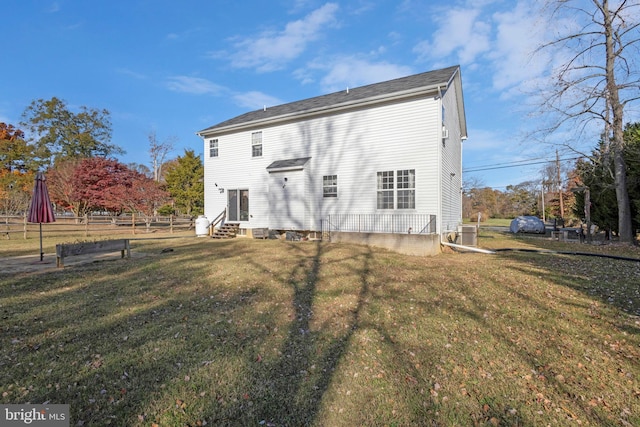 back of property with a lawn