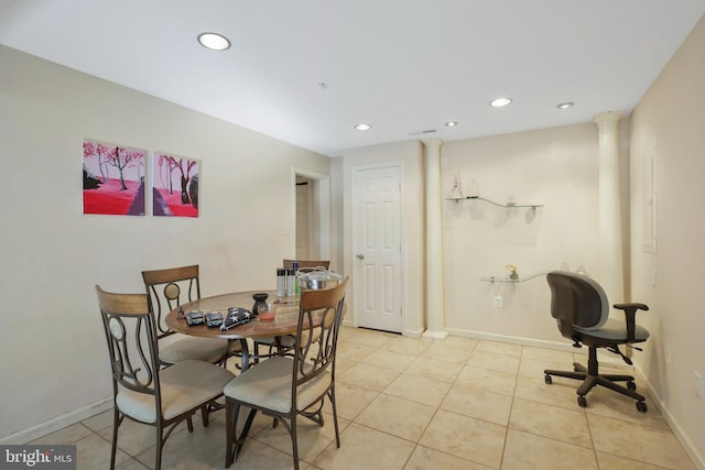 dining room with light tile patterned floors and decorative columns