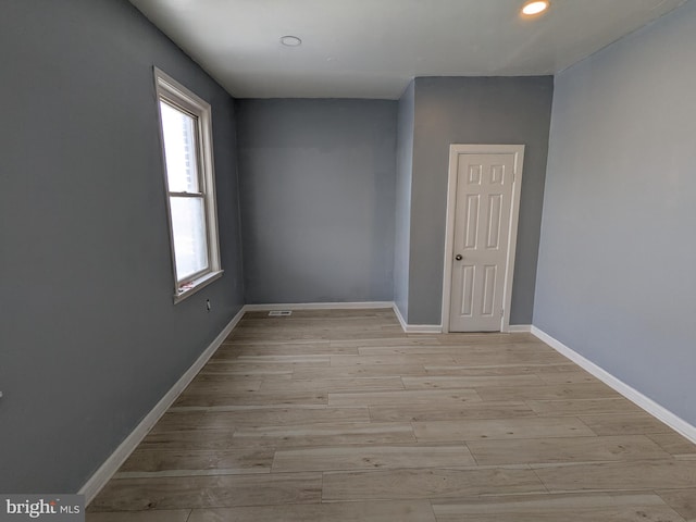 spare room featuring light wood-type flooring