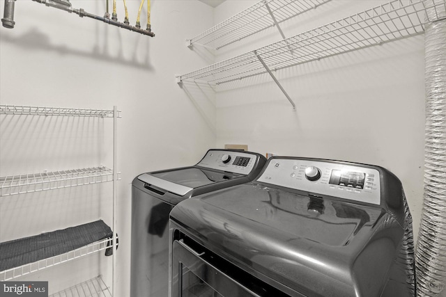 laundry room featuring washing machine and clothes dryer