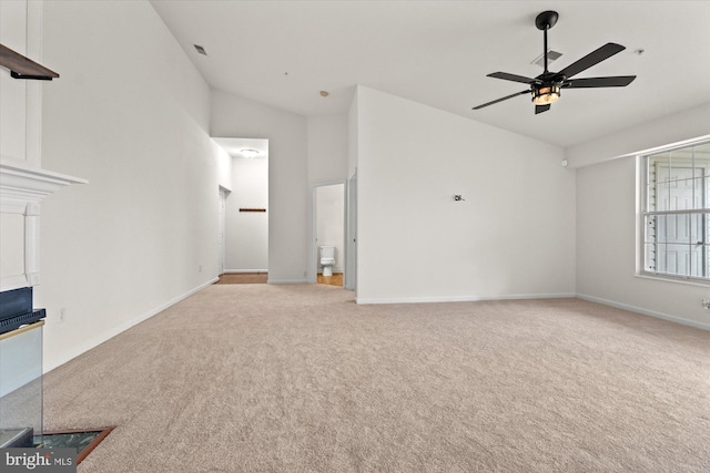 unfurnished living room featuring ceiling fan, light carpet, and high vaulted ceiling