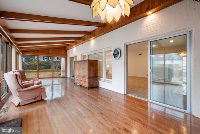 interior space with vaulted ceiling with beams and light wood-type flooring