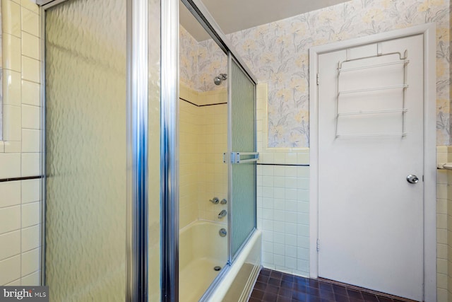 bathroom with enclosed tub / shower combo, tile walls, and tile patterned floors