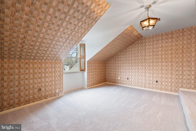 additional living space with lofted ceiling and carpet flooring