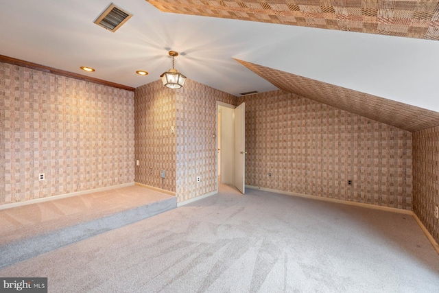 bonus room with vaulted ceiling and carpet flooring