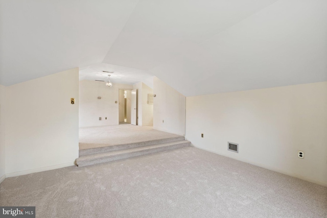 additional living space with lofted ceiling and light colored carpet